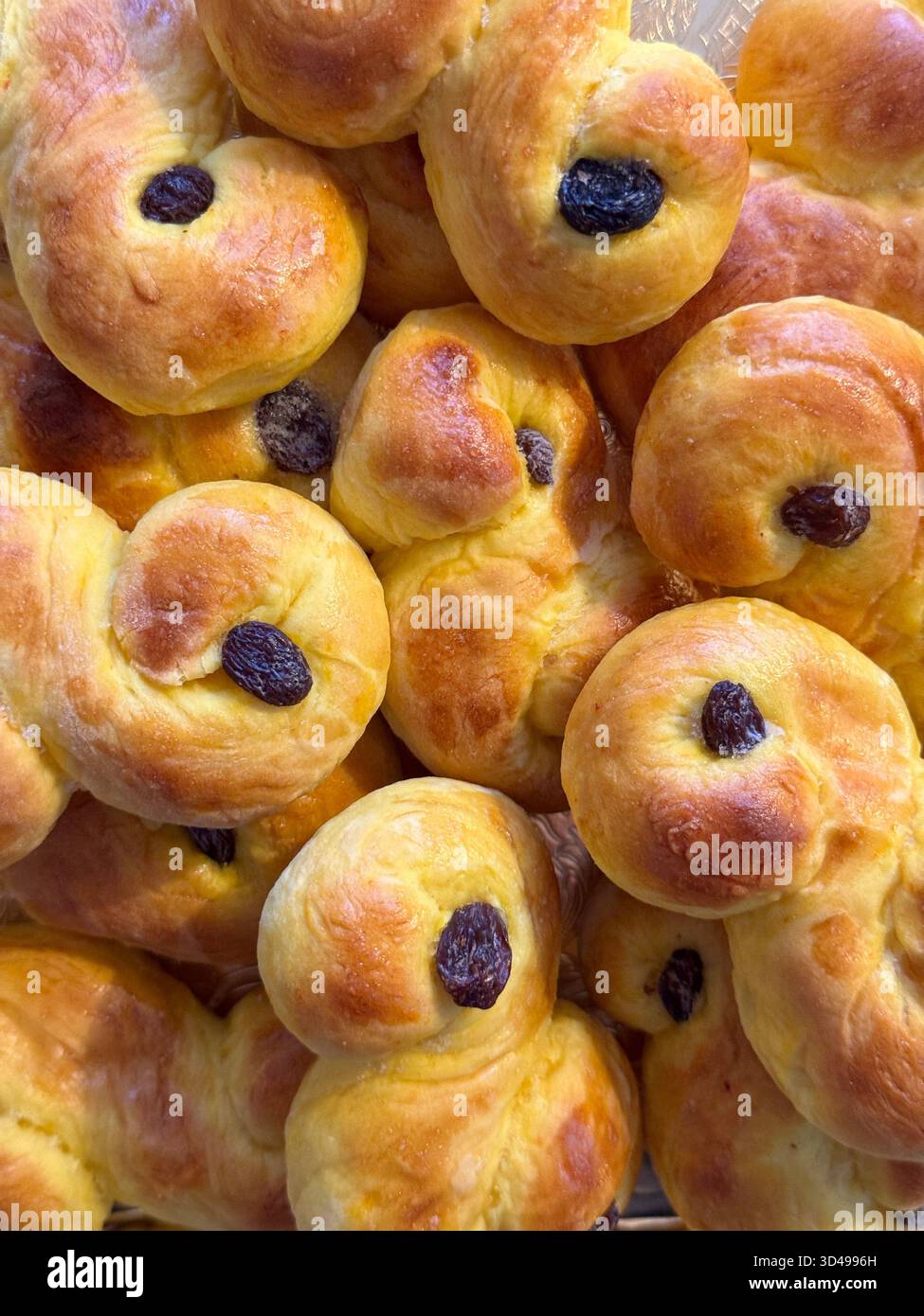 Freshly baked traditional Swedish saffron buns, called Lussekatter, made for St. Lucia Day and Christmas celebrations in Sweden. - Smartphone Captured Stock Image