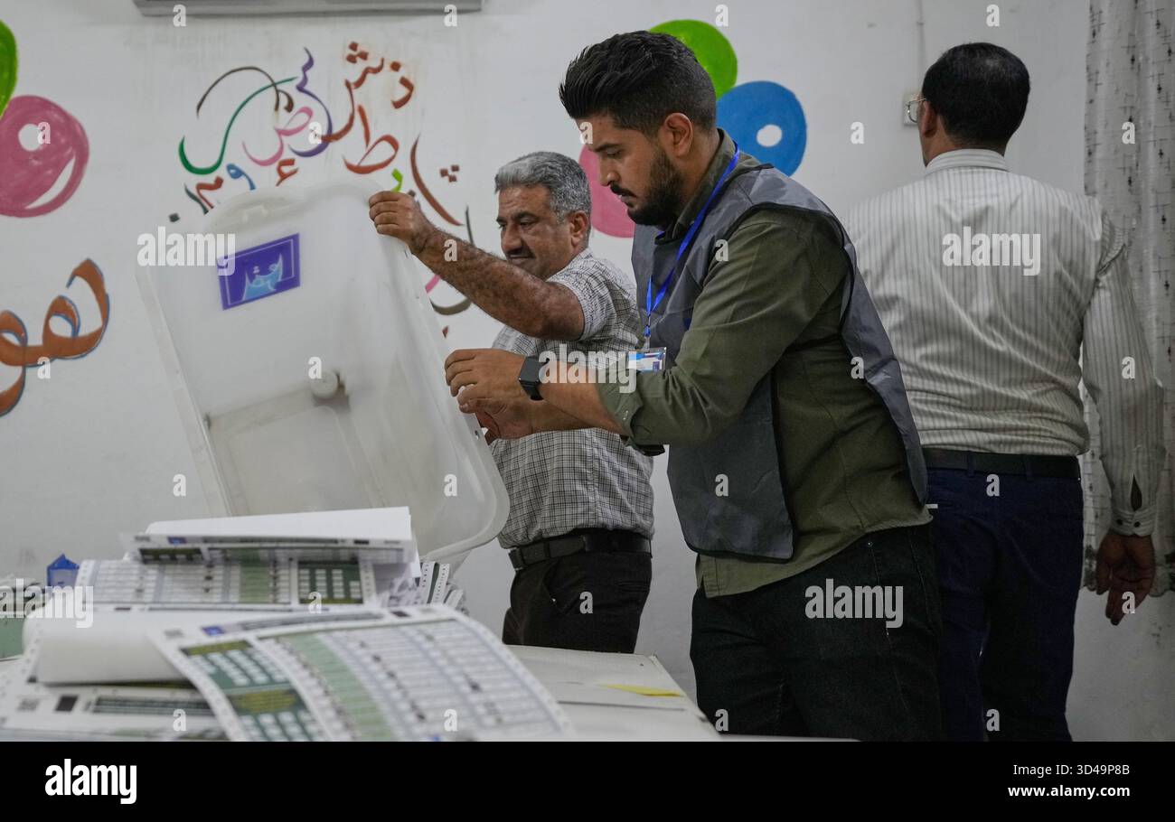 Election workers count ballots at the end of a special voting session ...