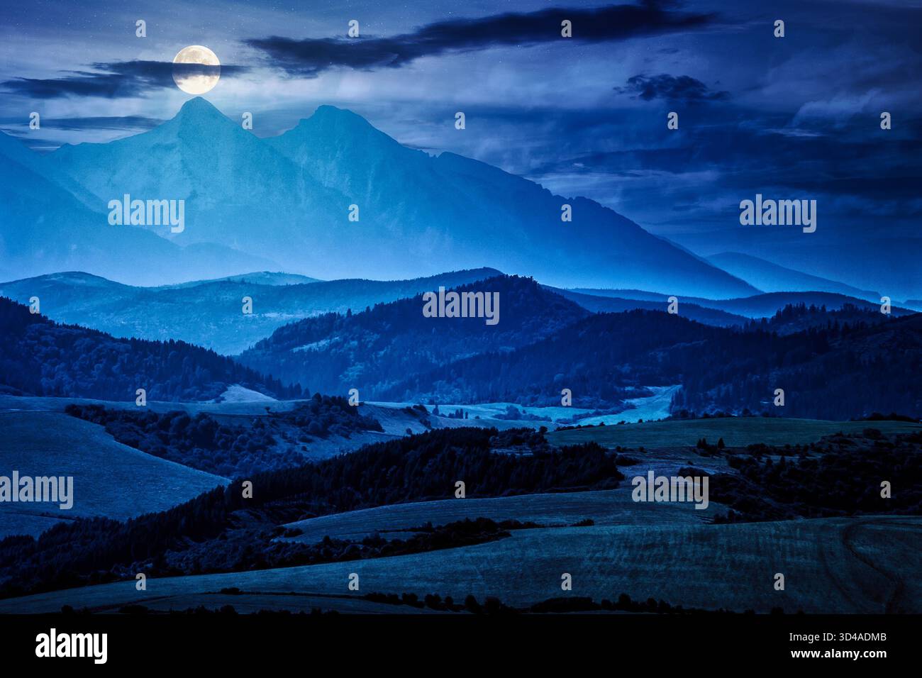 Rural landscape with fields and forest at the foot of mountains at night in full moon light. background for investment or abstract concepts Stock Photo