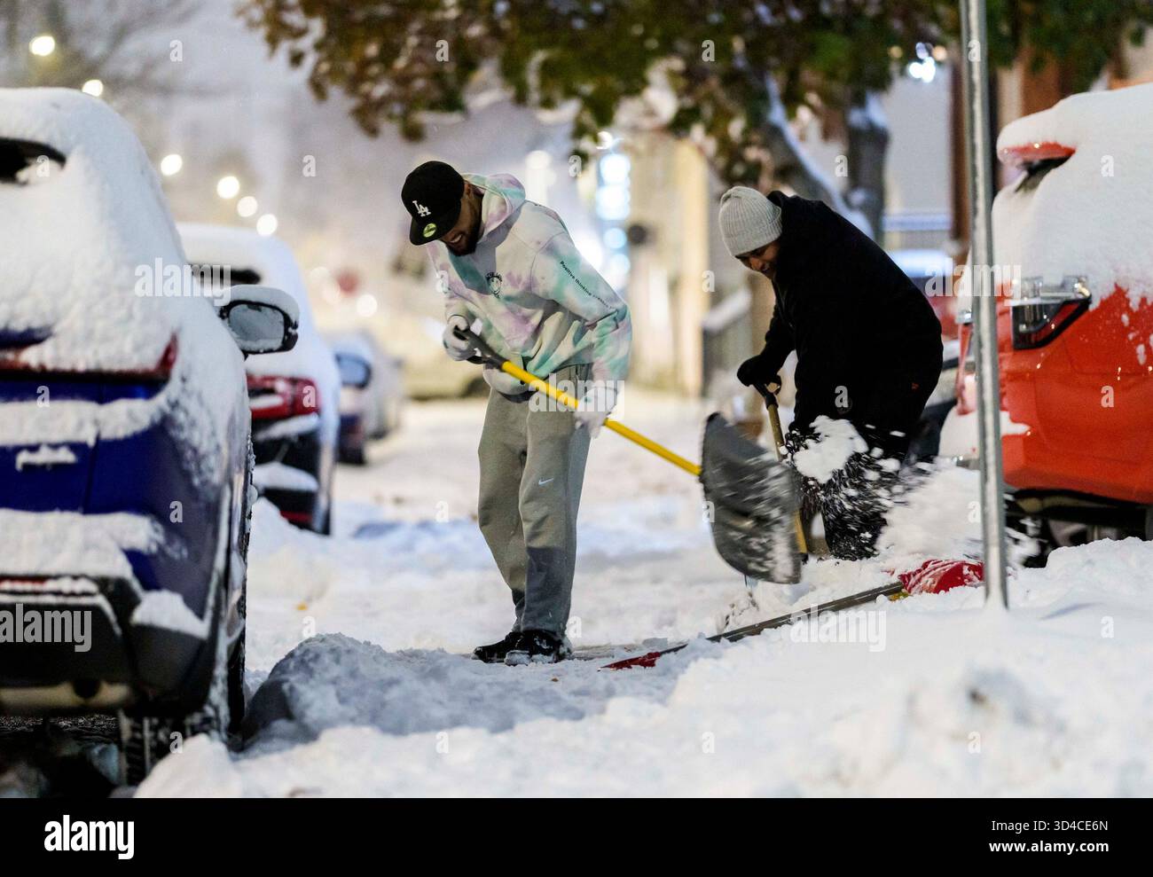 Snow Washing Snow removal workers shovel the walkway of a residence in Ottawa on ...