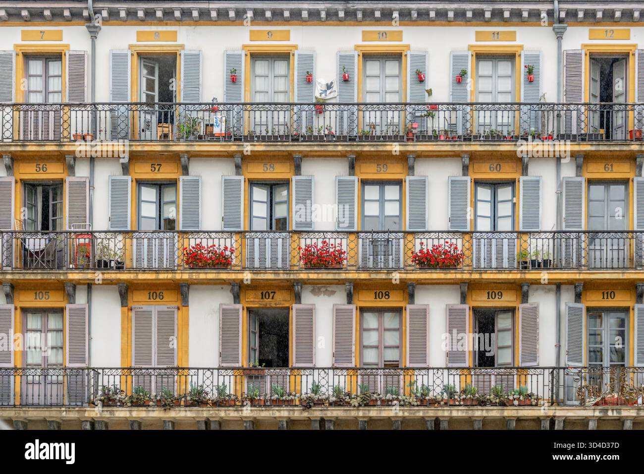 Image showcasing Traditional Apartment Building Facade, Numbered Yellow Doors, Multiple ...