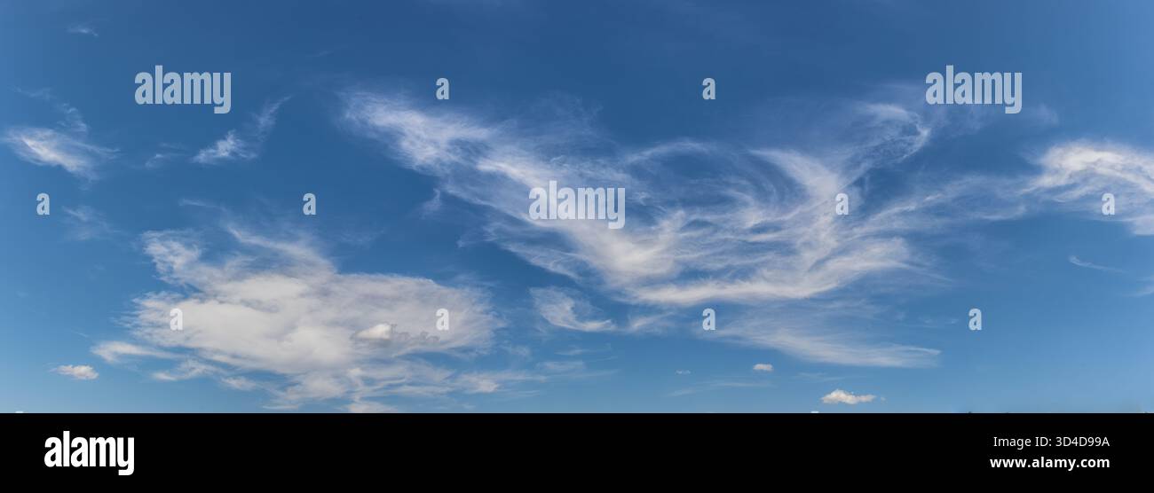Fluffy white clouds float freely in a clear blue sky creating serene ...