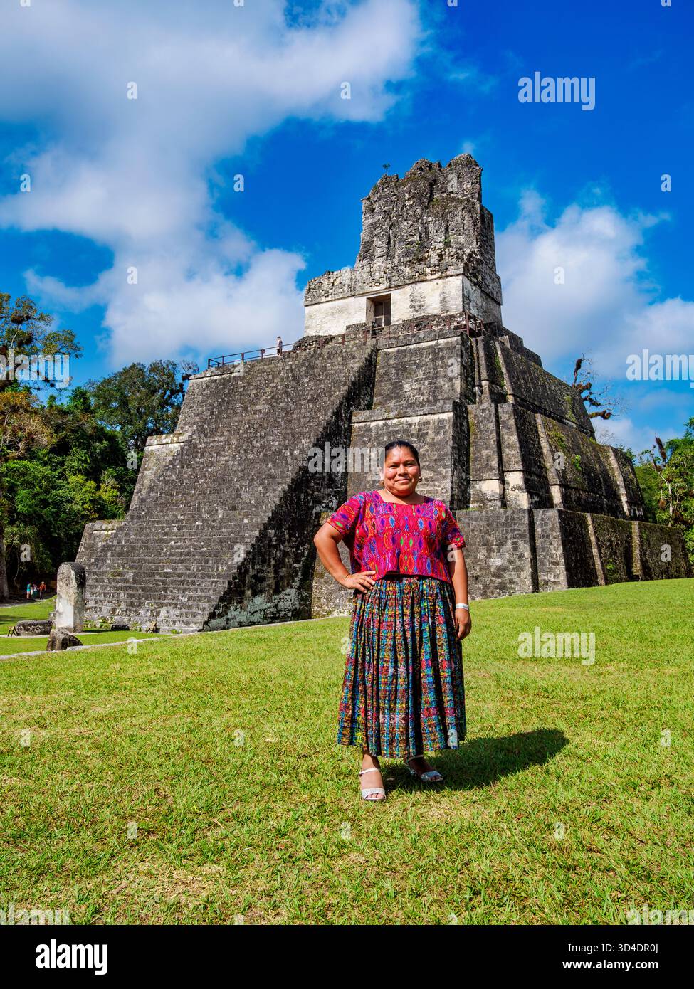 Native lady in front of the Temple II or Temple of the Masks, Great Plaza, Tikal, Peten Department, Guatemala Stock Photo