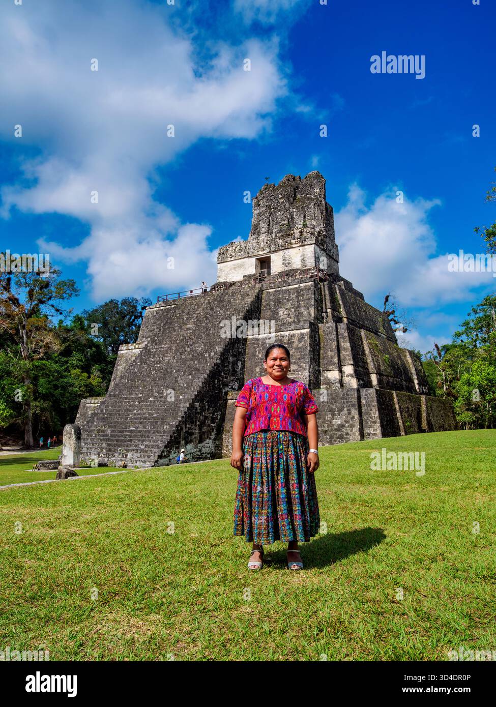 Native lady in front of the Temple II or Temple of the Masks, Great Plaza, Tikal, Peten Department, Guatemala Stock Photo