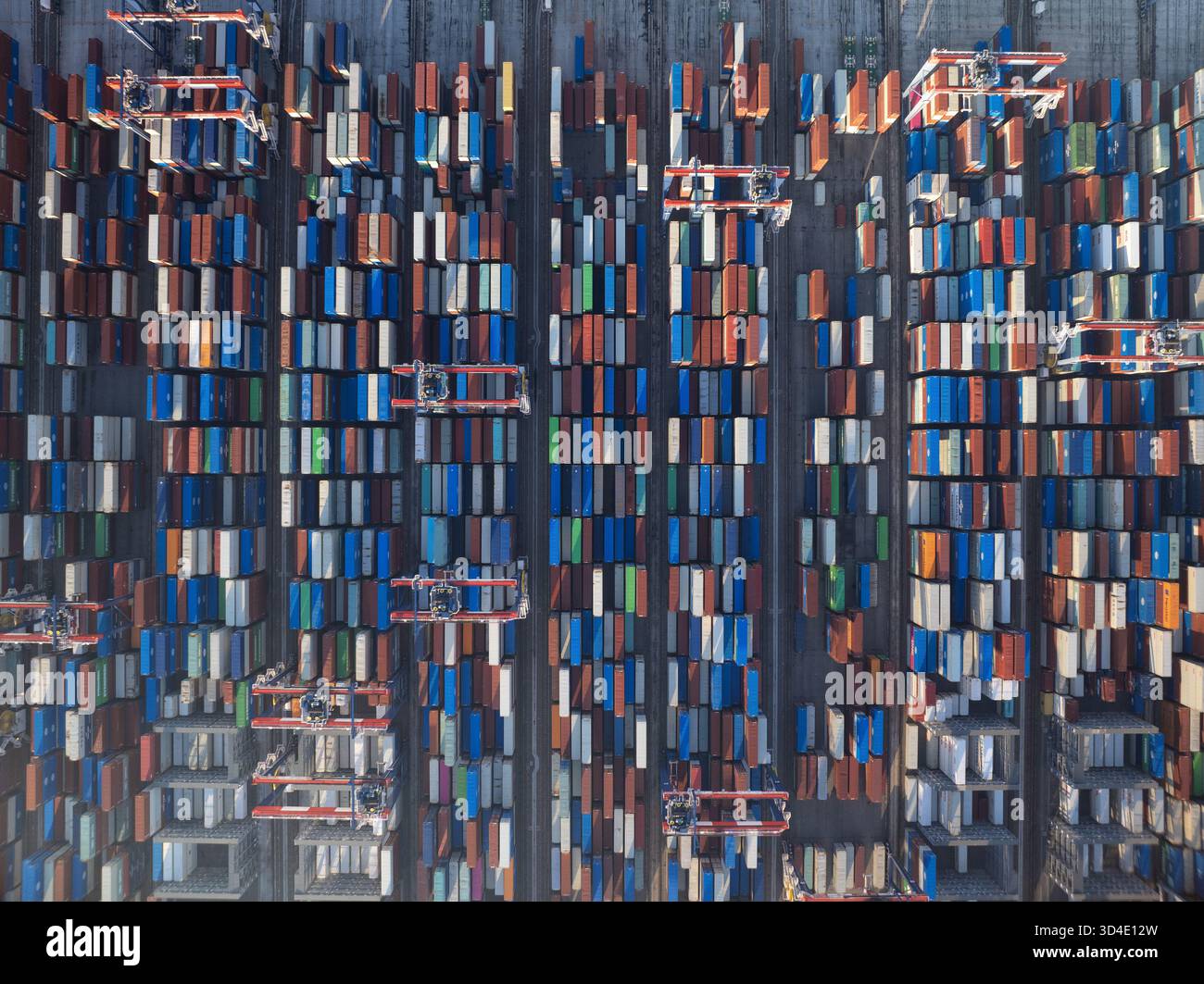 Aerial view of a sea of stacked, multicolored shipping containers, like ...