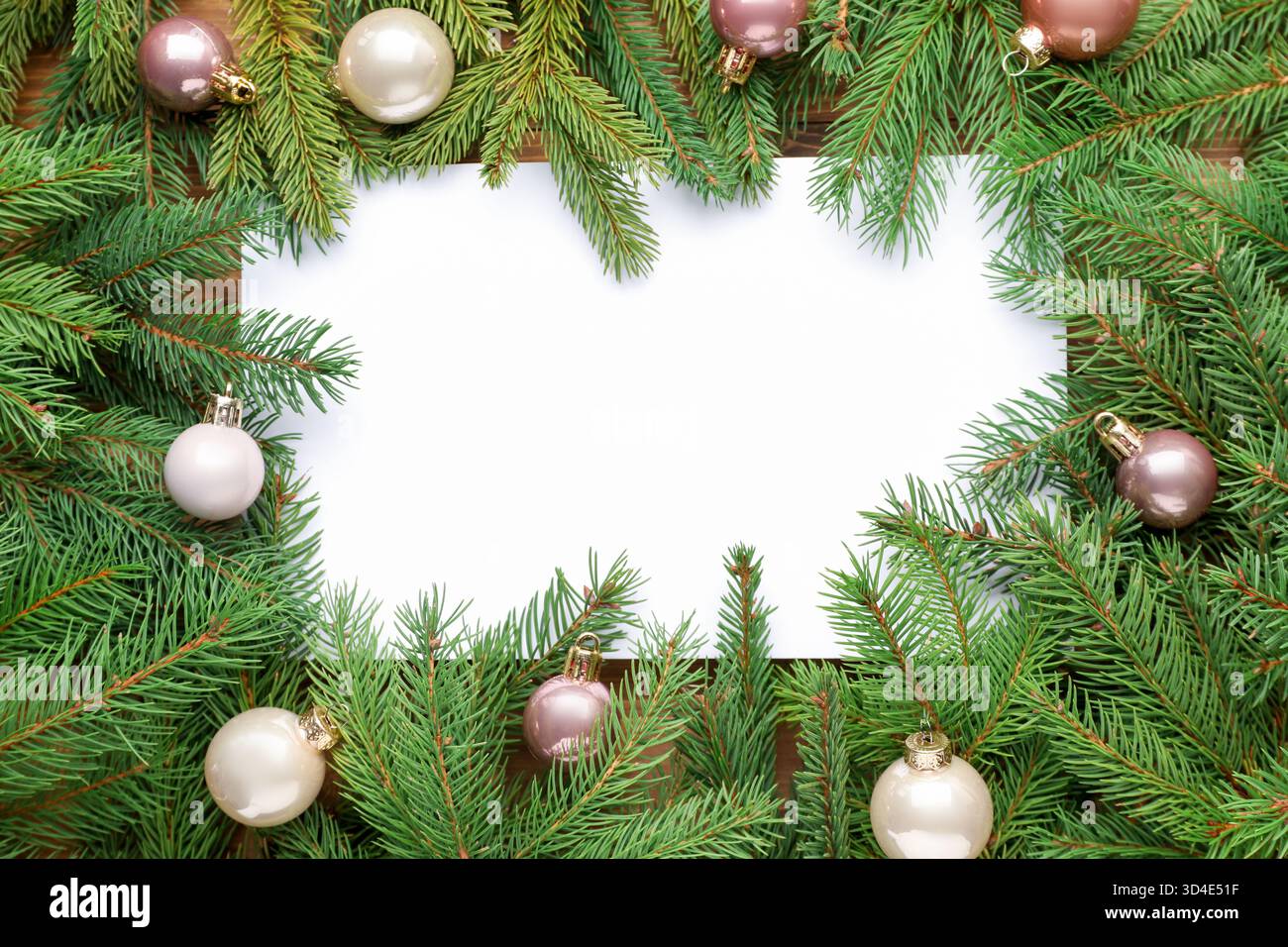 Frame made of Christmas tree branches with baubles and blank card on ...