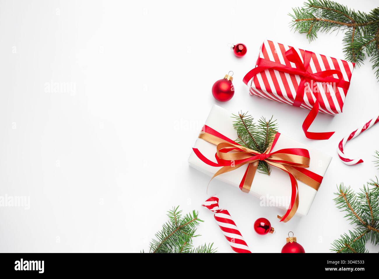 Fir tree branches, gift boxes and Christmas decor on white background ...