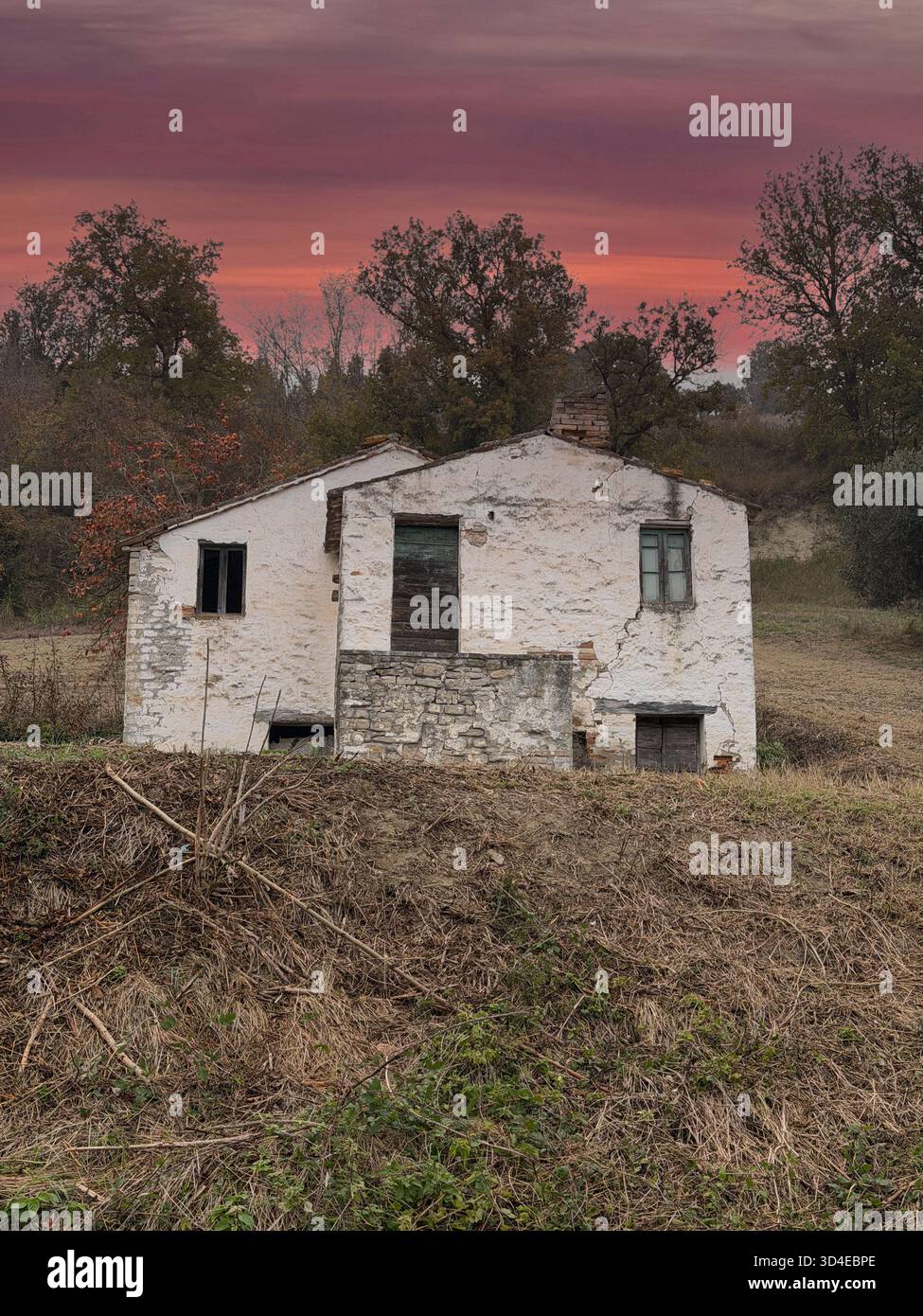Old abandoned country house with red afternoon sky, Fermo province, Marche region, Italy - Smartphone Captured Stock Image