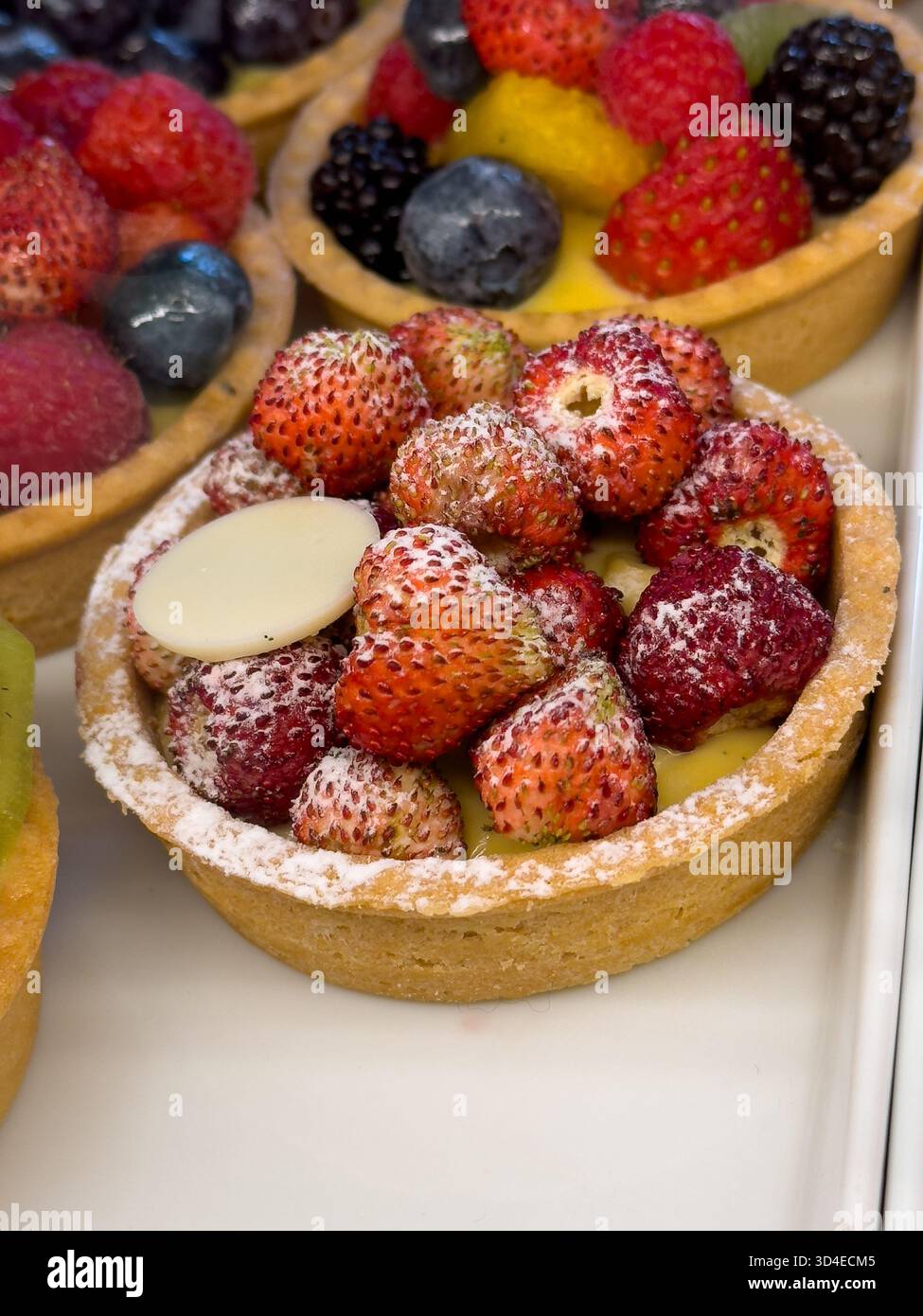 Vibrant berry tart with creamy custard under crown of fresh fruit golden crust powdered sugar inviting dessert for celebrations and gatherings Stock Photo