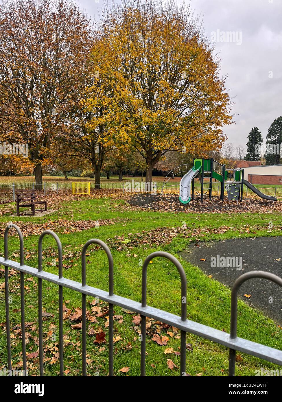 Autumn Children’s Playground with Metal Fence in England - Smartphone Captured Stock Image