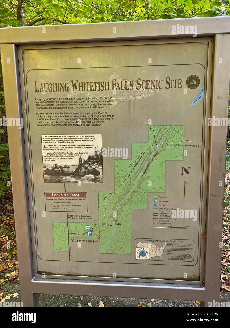 An informational sign, with trail map, at Laughing Whitefish Falls Scenic Site in the upper peninsula of Michigan, USA - Smartphone Captured Stock Image