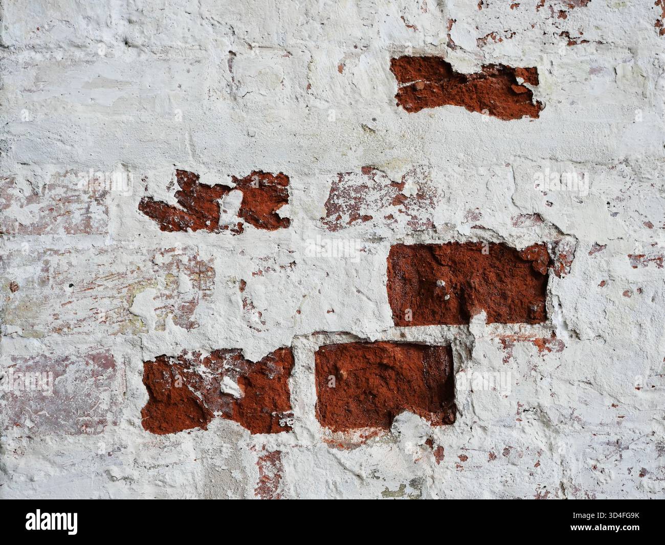 Weathered brick wall with peeling plaster historic facade and texture. Copyspace. Stock Photo
