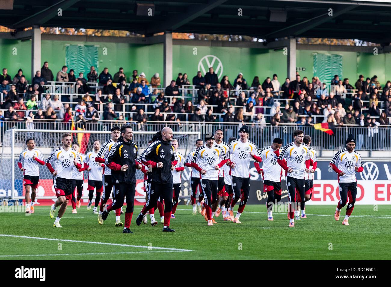 Warm-up, The team runs a group around the field DFB Men's Training Camp ...