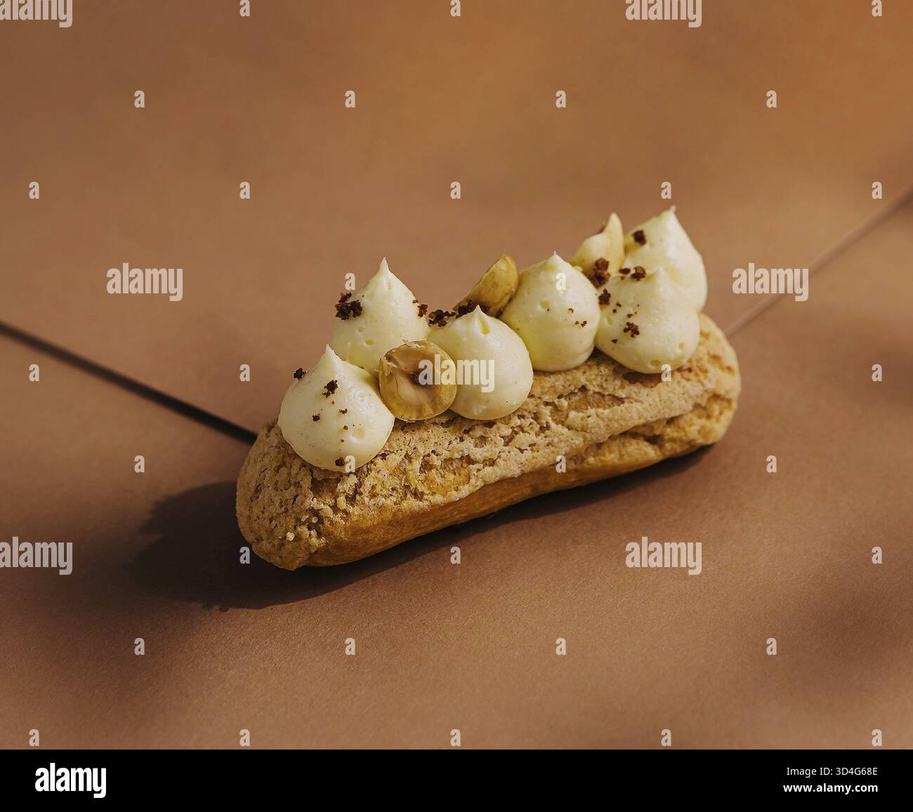 Food, Eclair with whipped cream and hazelnuts Stock Photo