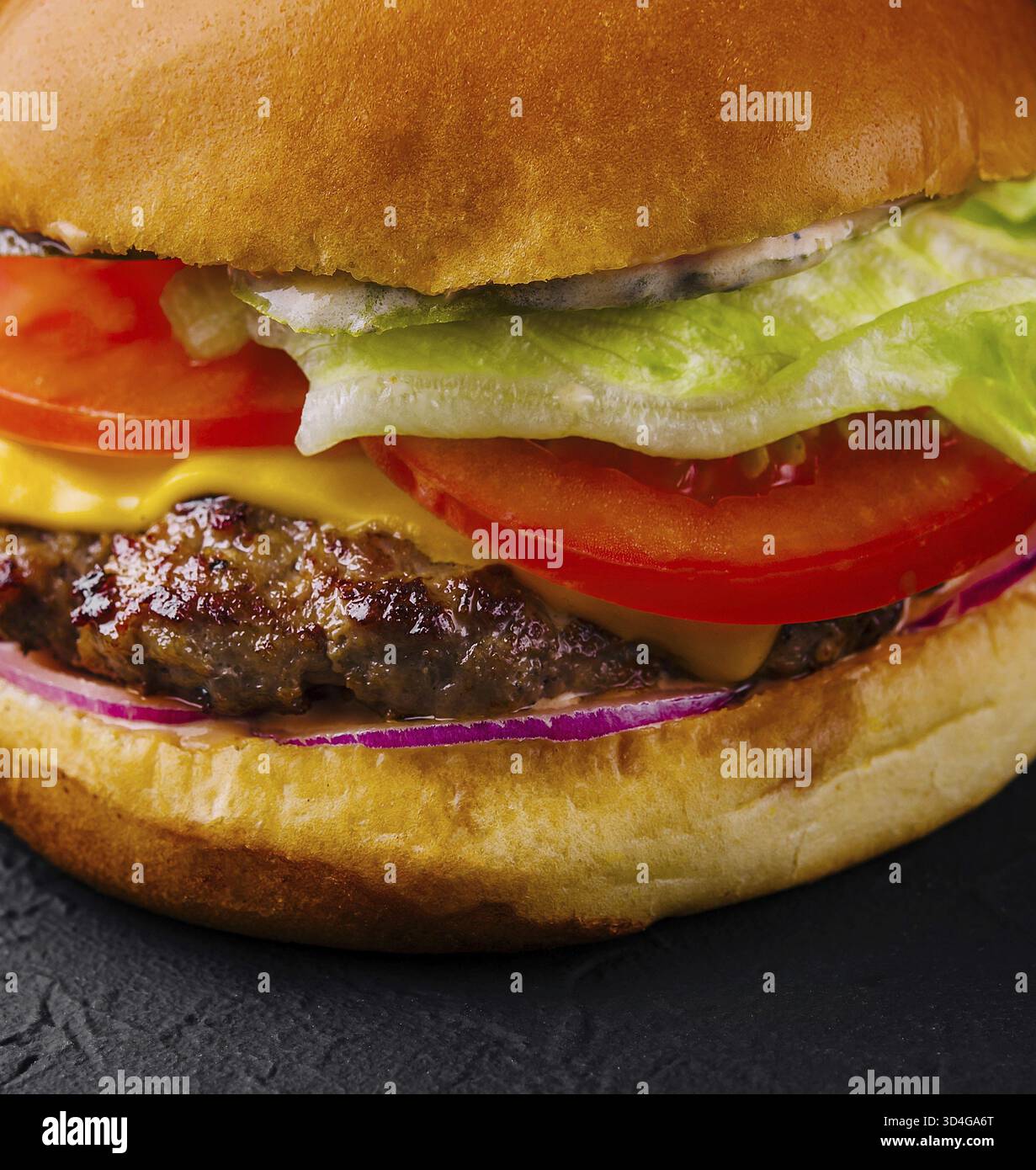 Food, Appetizing cheeseburger on black stone closeup Stock Photo