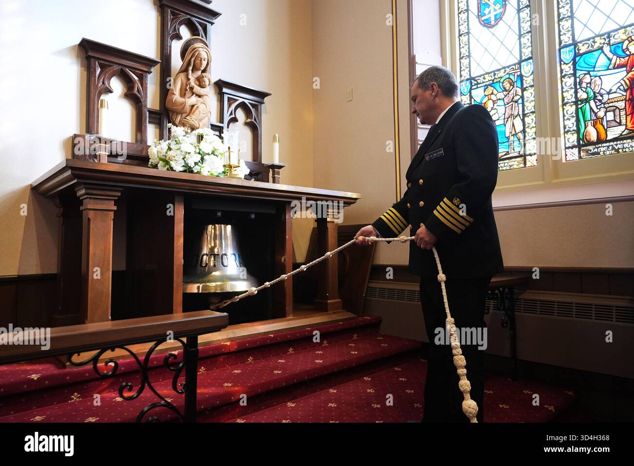 A bell is rung at the annual Great Lakes memorial service to ...
