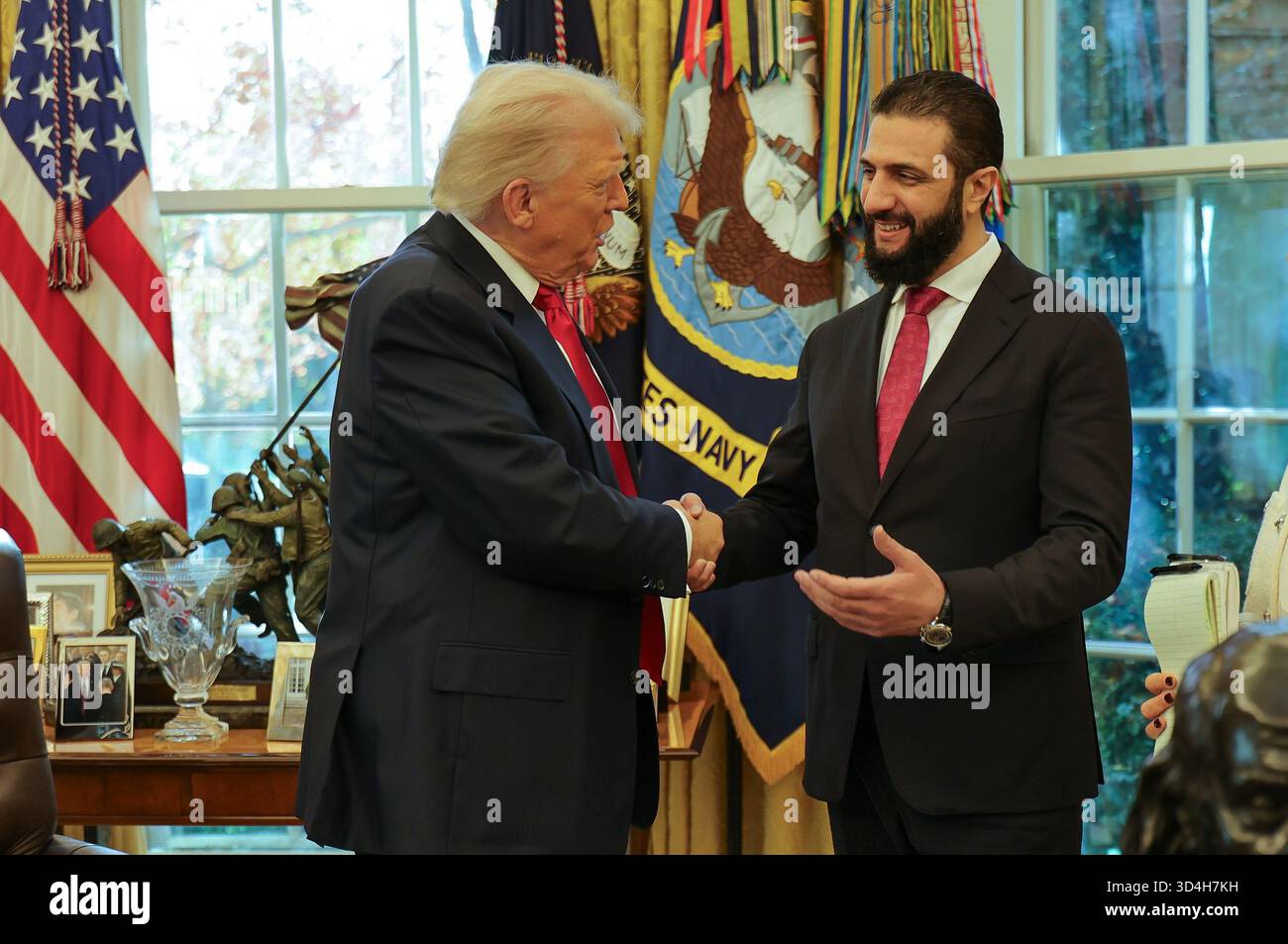 In this photo released by Syrian Presidency press office, President Donald Trump, left, shakes hands with Syria's President Ahmad al-Sharaa, at the White House in Washington, Monday, Nov. 10, 2025. (Syrian Presidency press office via AP) Stock Photo