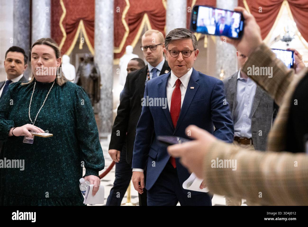 House Speaker Mike Johnson (R-La.) speaks with reporters as he walks to ...