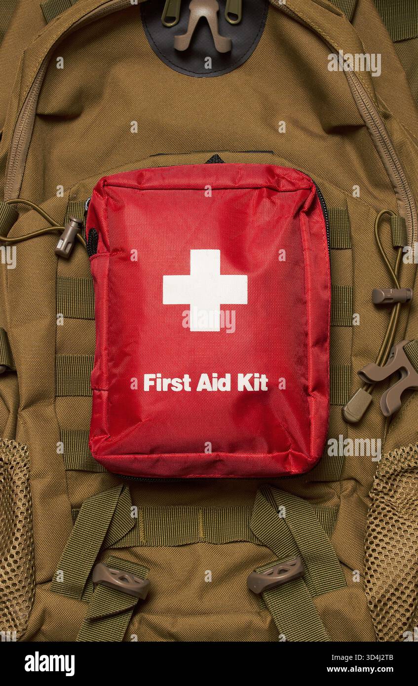 First Aid Kit on army backpack background Stock Photo - Alamy