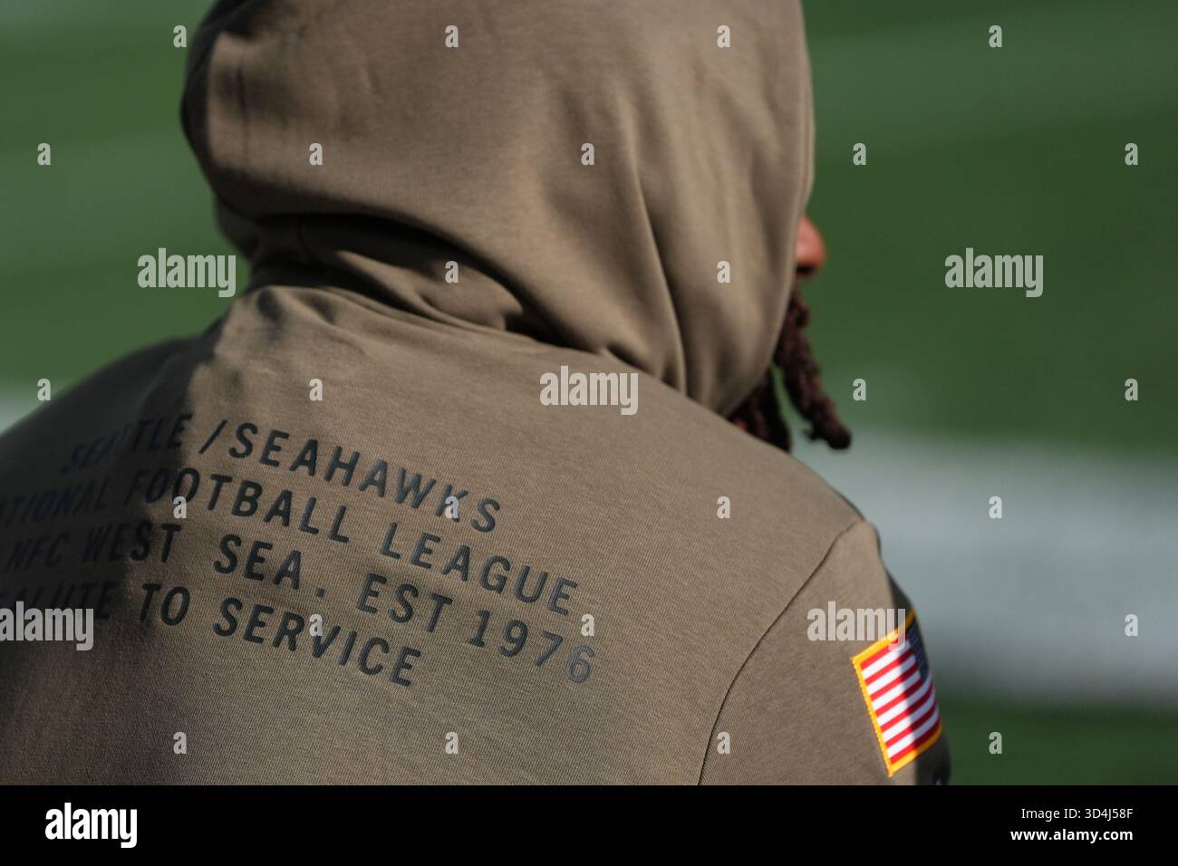 A Seattle Seahawks player wears an NFL Salute to Service hoodie before ...
