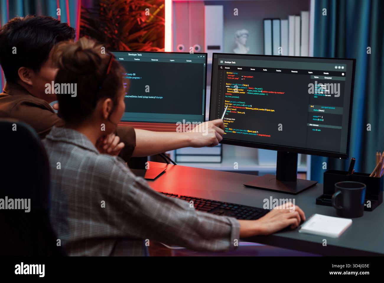 Smart IT developer looking at coding program application on computer screen of online website at back side, analyzing intelligent database system Stock Photo