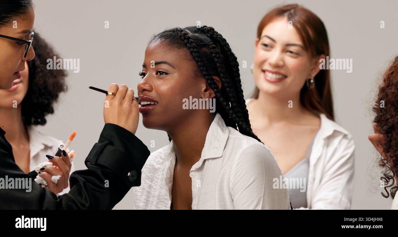 Backstage, getting ready and makeup with women in studio for fashion showcase preparation. Behind the scenes, beauty or cosmetics with cosmetologist Stock Photo