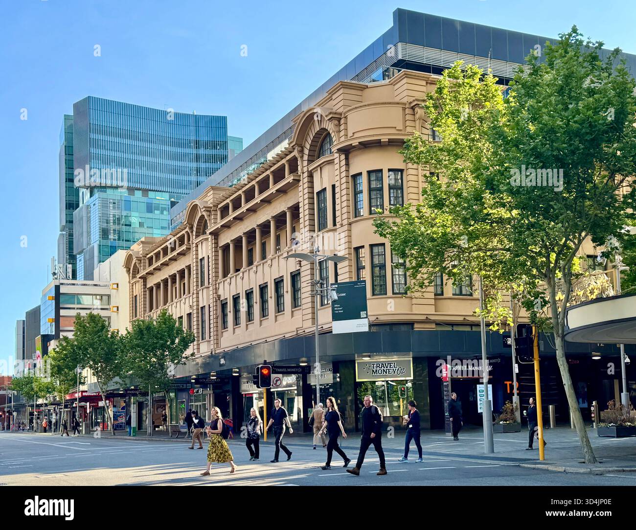 Pedestrians crossing the road at Walsh's Building with One40willian office building in background on William Street Perth Western Australia - Smartphone Captured Stock Image