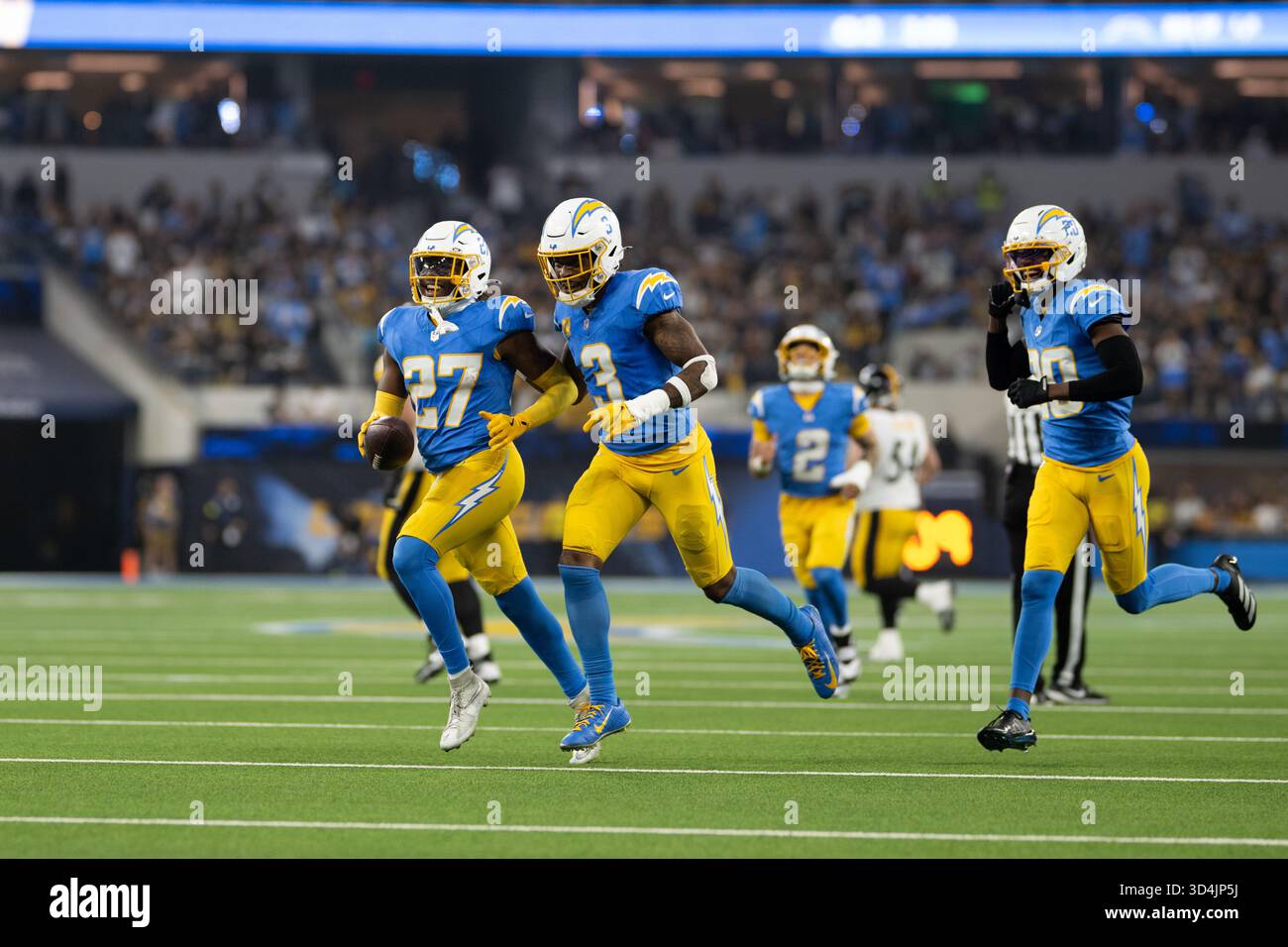 Los Angeles Chargers players celebrate an interception by safety RJ ...