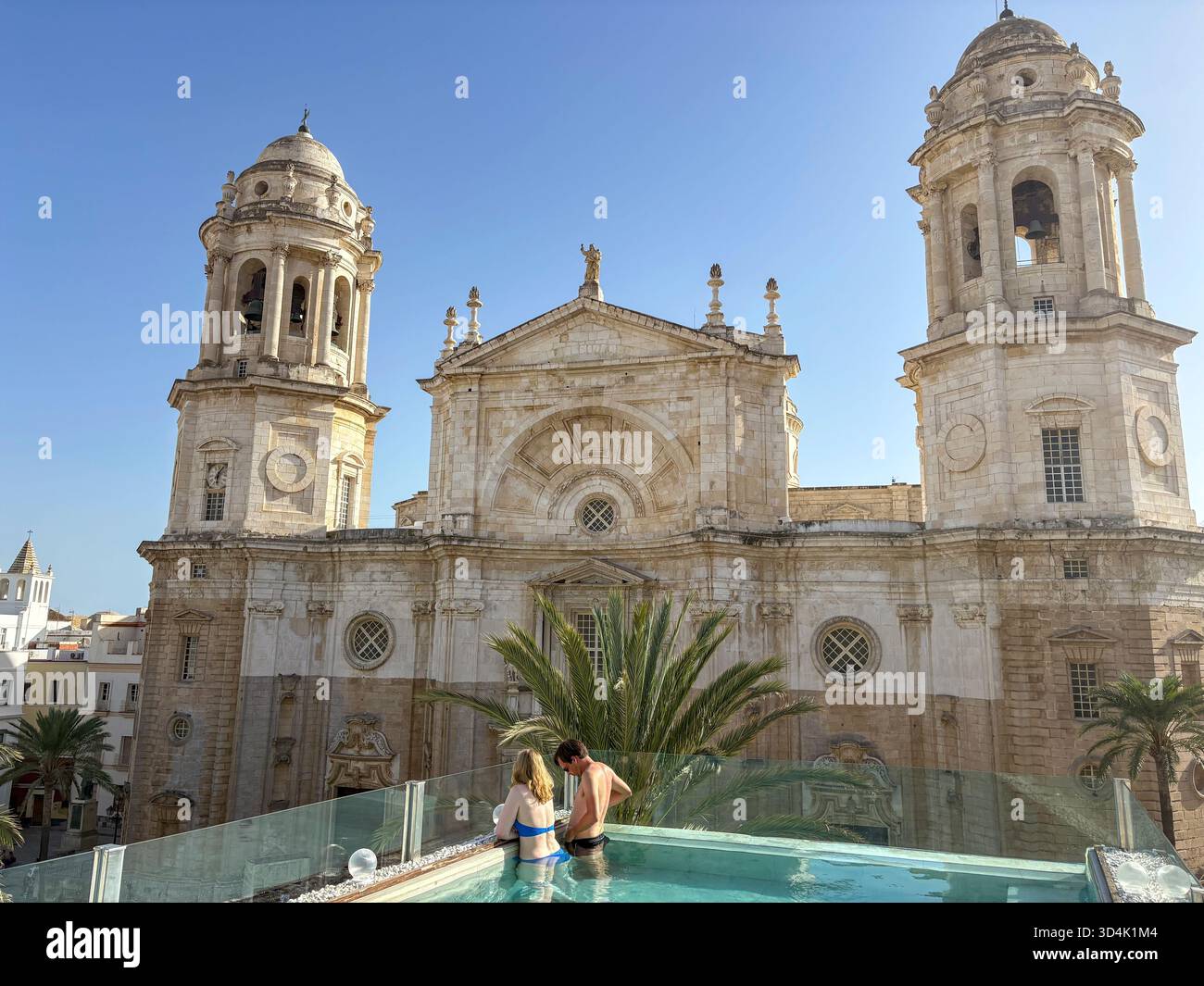 Cadiz Cathedral, young couple in the rooftop swimming pool of Hotel Olom in Cadiz city centre, Andalusia,Spain,Europe - Smartphone Captured Stock Image