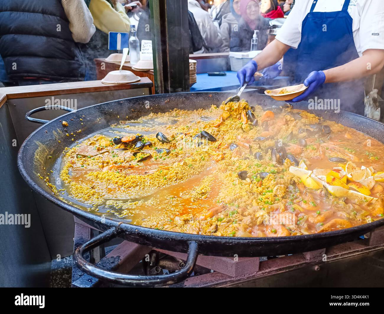 Spanish paella cooking at a busy street food market. London, UK, 17 December 2023 Stock Photo
