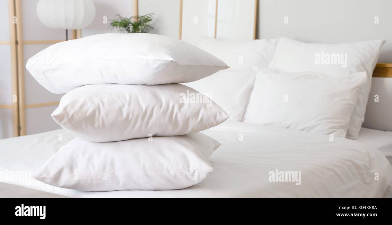 Stack of soft pillows on bed Stock Photo
