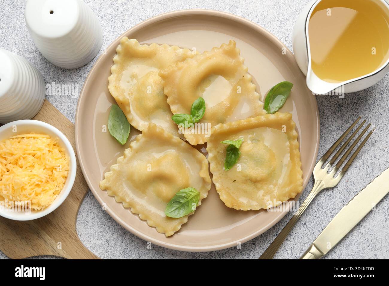 Delicious ravioli with basil served on light grey table, flat lay Stock ...