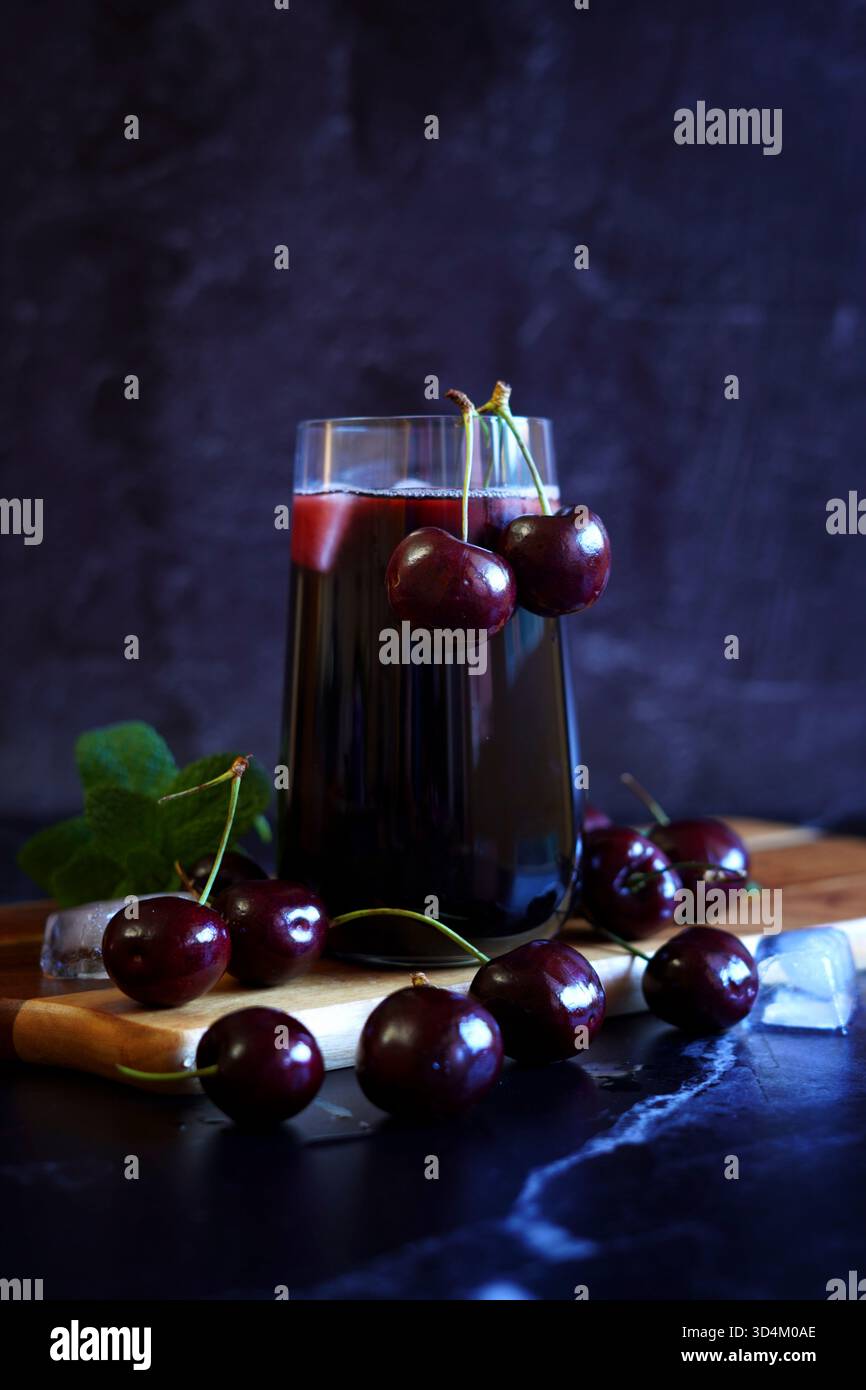 Pure Black Cherry Juice on Dark Background. Stock Photo