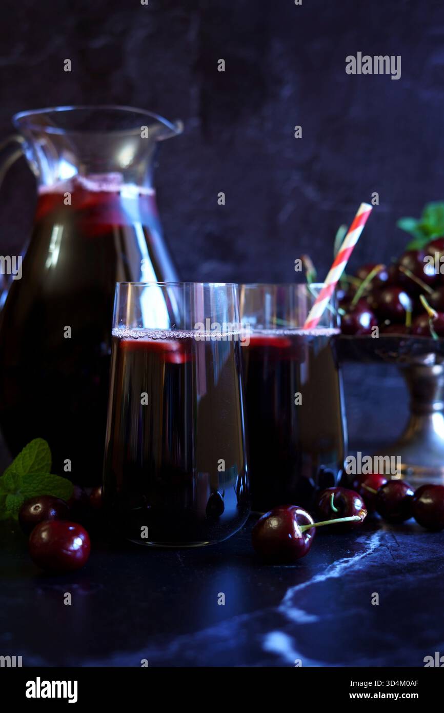 Pure Black Cherry Juice on Dark Background. Stock Photo