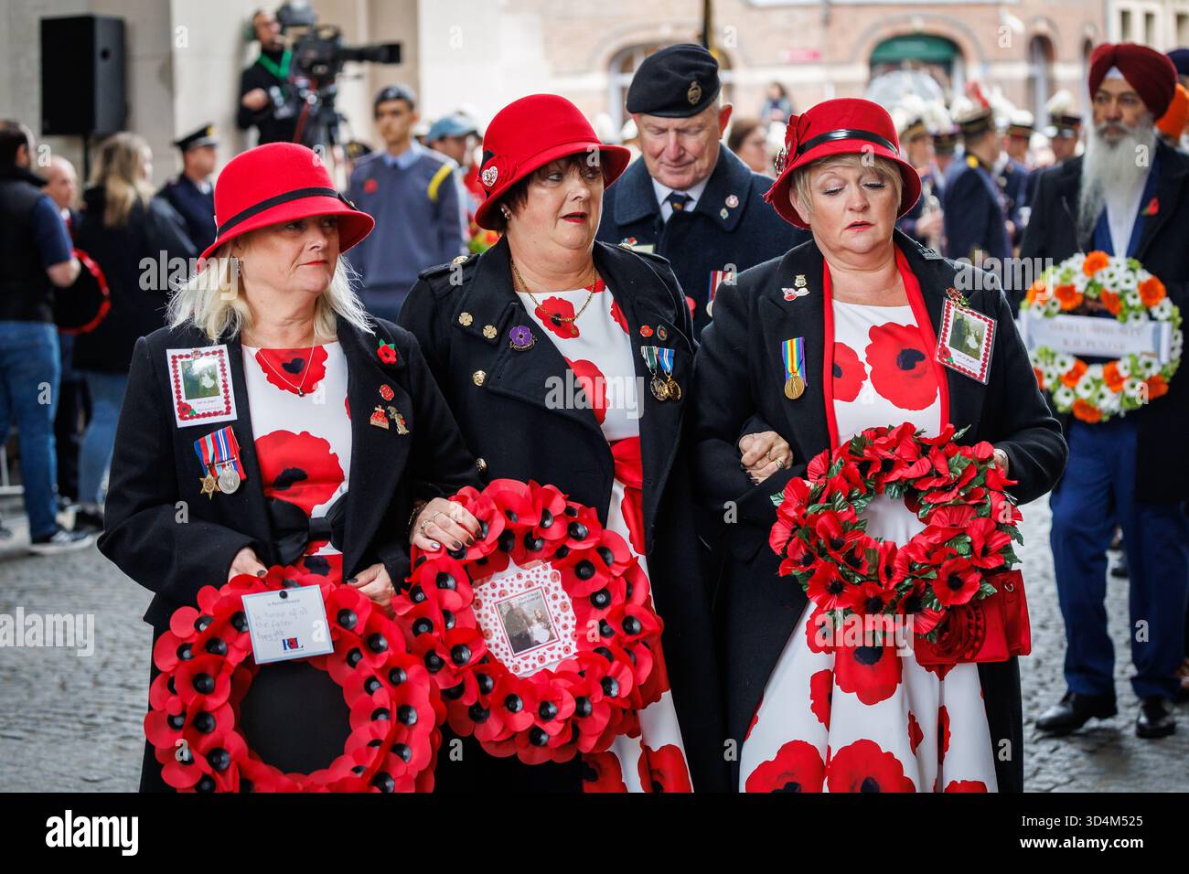 British citizens carrying poppy wreaths during the 'Poppy Parade' walk ...