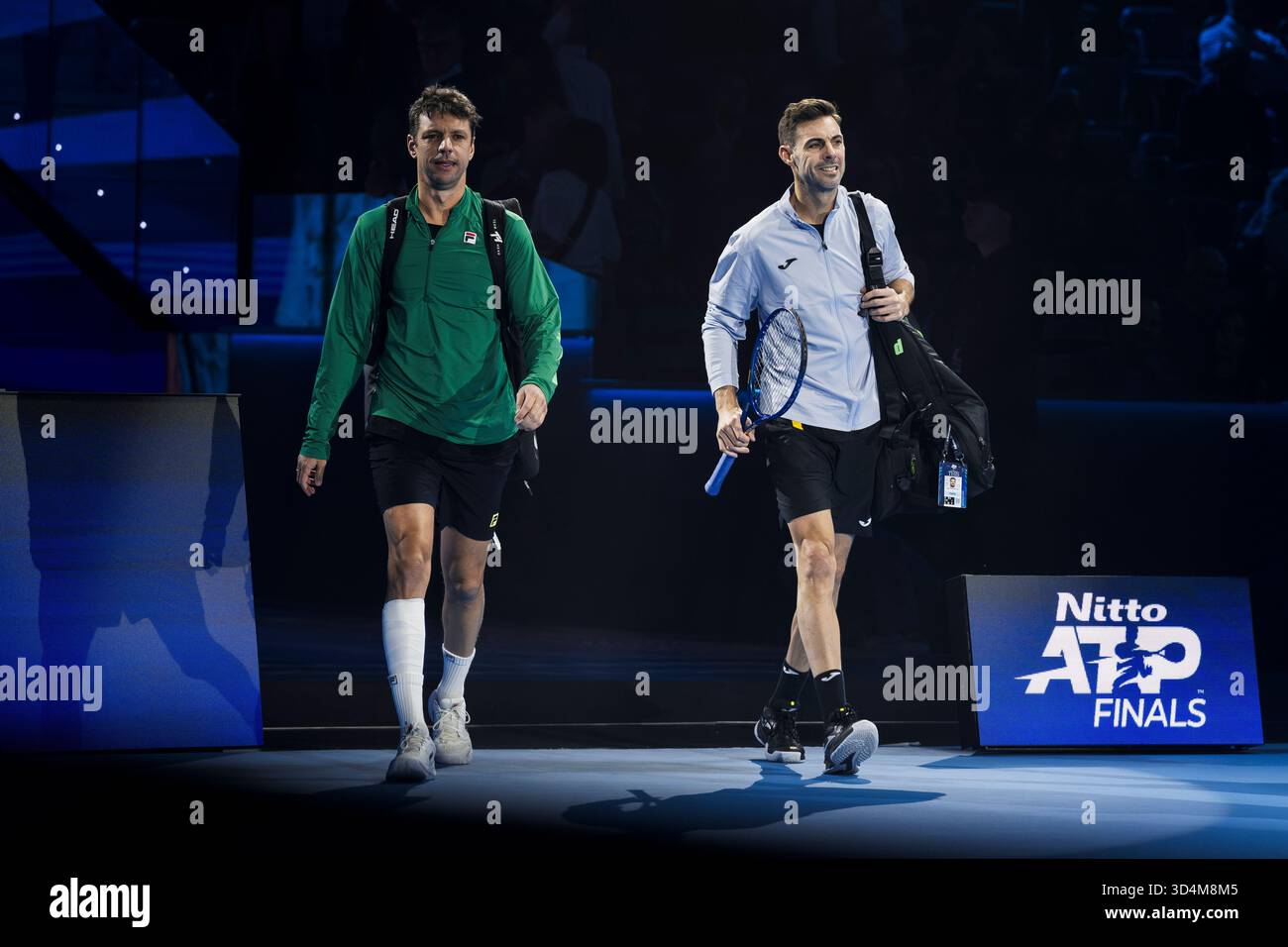 Marcel Granollers (R) of Spain and Horacio Zeballos of Argentina walk out prior to their round robin doubles match against Simone Bolelli and Andrea Vavassori of Italy during day three of the Nitto ATP Finals 2025. Simone Bolelli and Andrea Vavassori won 7-6(4), 6-4. Stock Photo