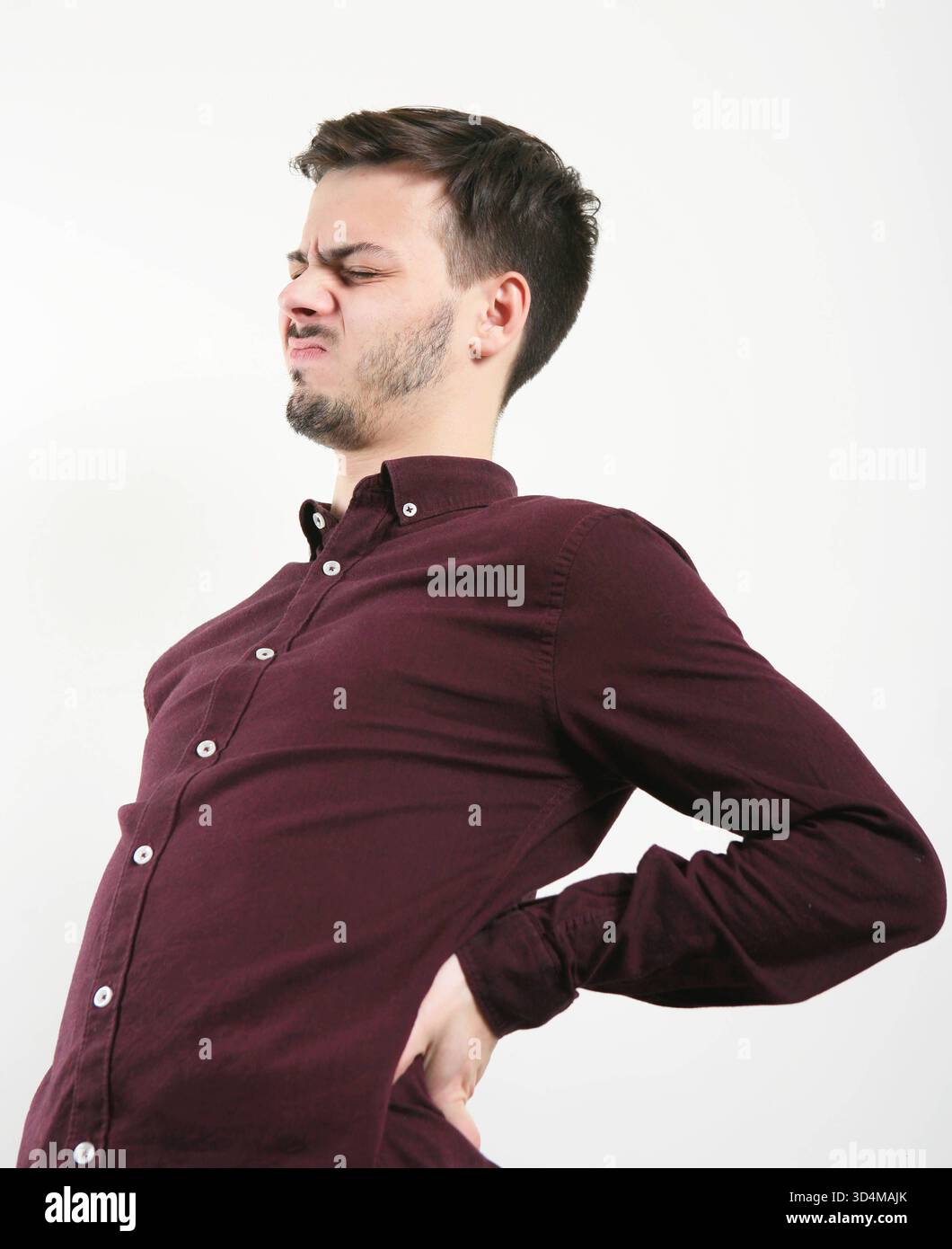 Back pain in a 23-year-old man Back pain 016560 004 Stock Photo - Alamy