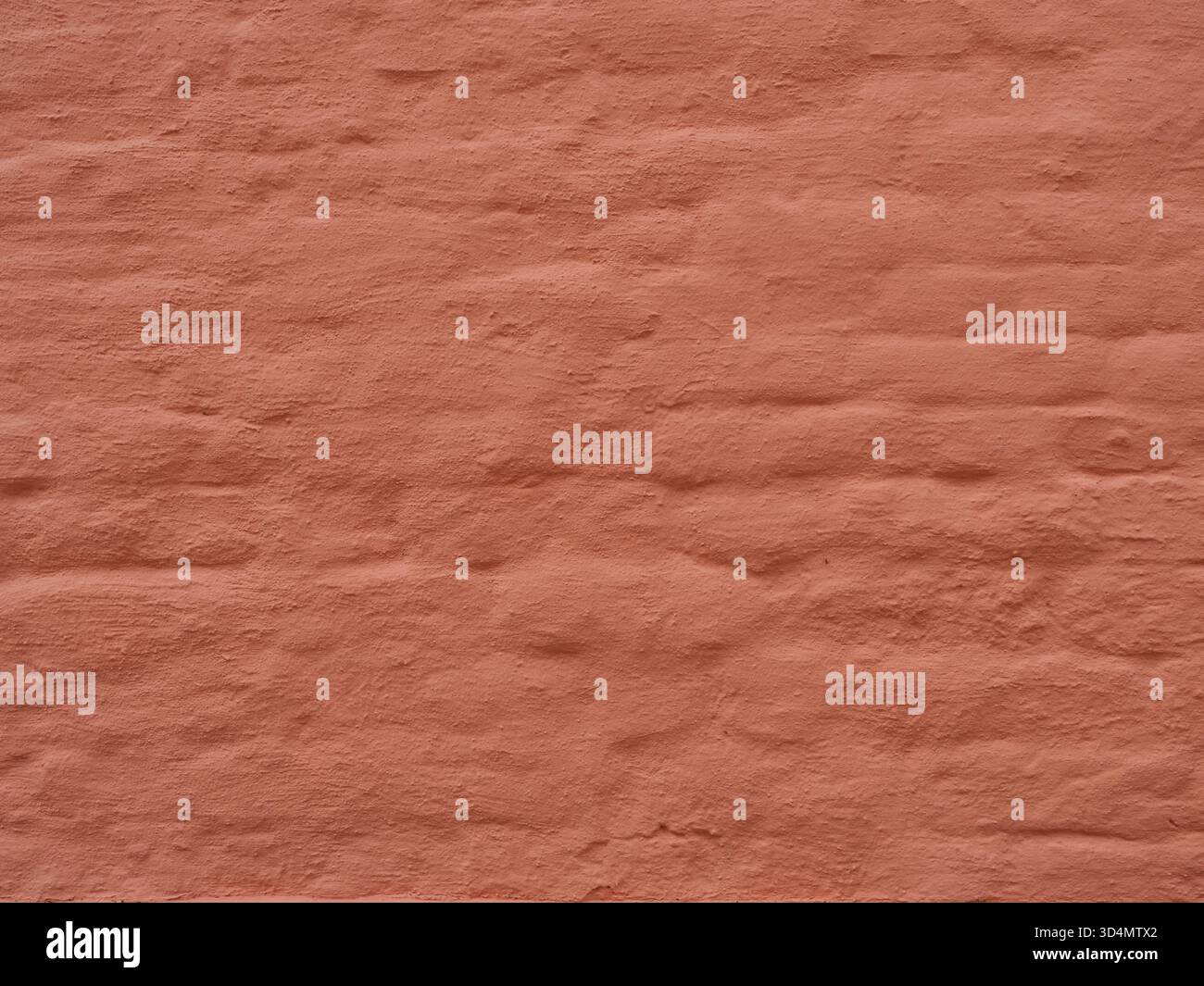 Matte reddish-orange brick wall with rough texture and visible joints. Copyspace Stock Photo