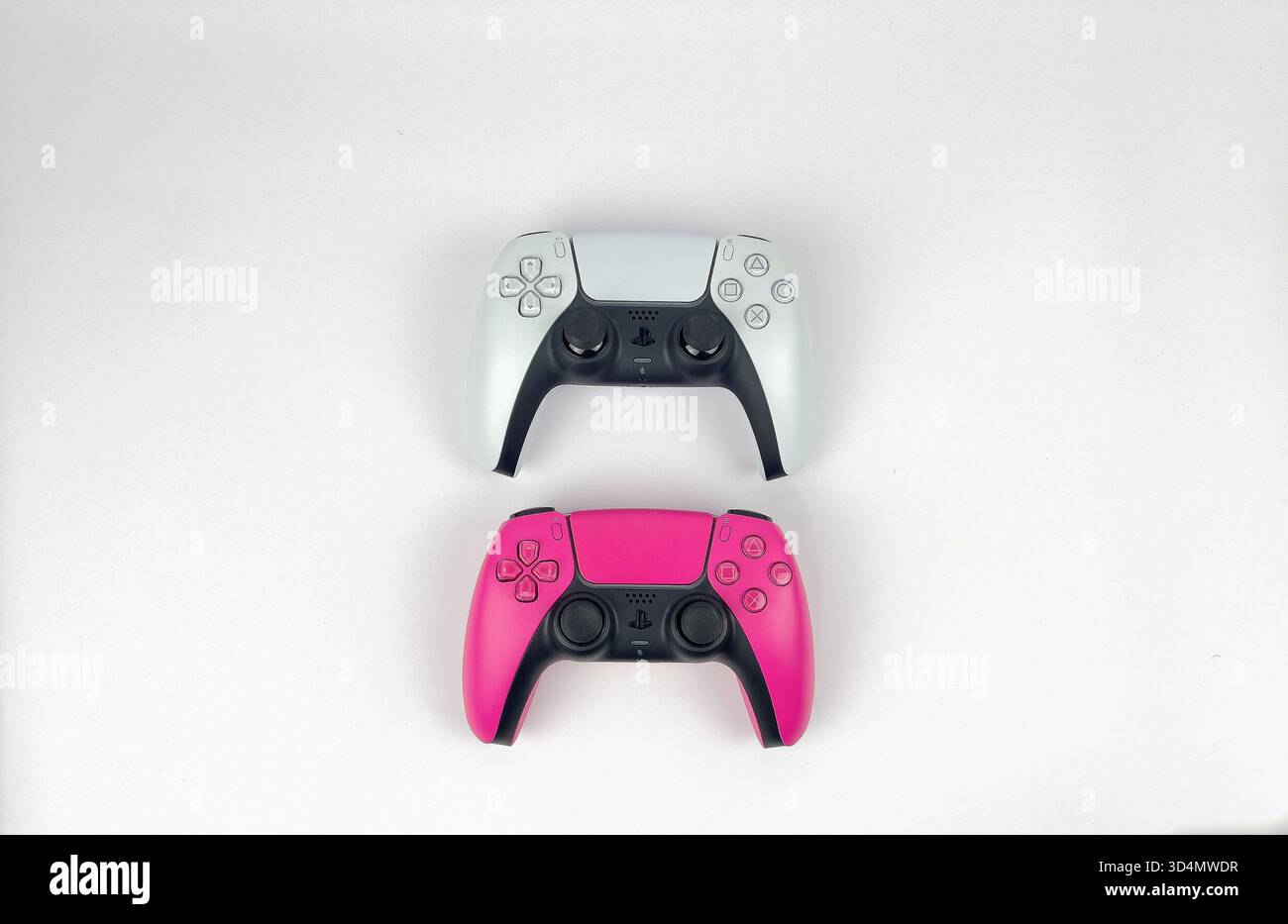 This is a flat lay or top-down photograph featuring two PlayStation 5 ...