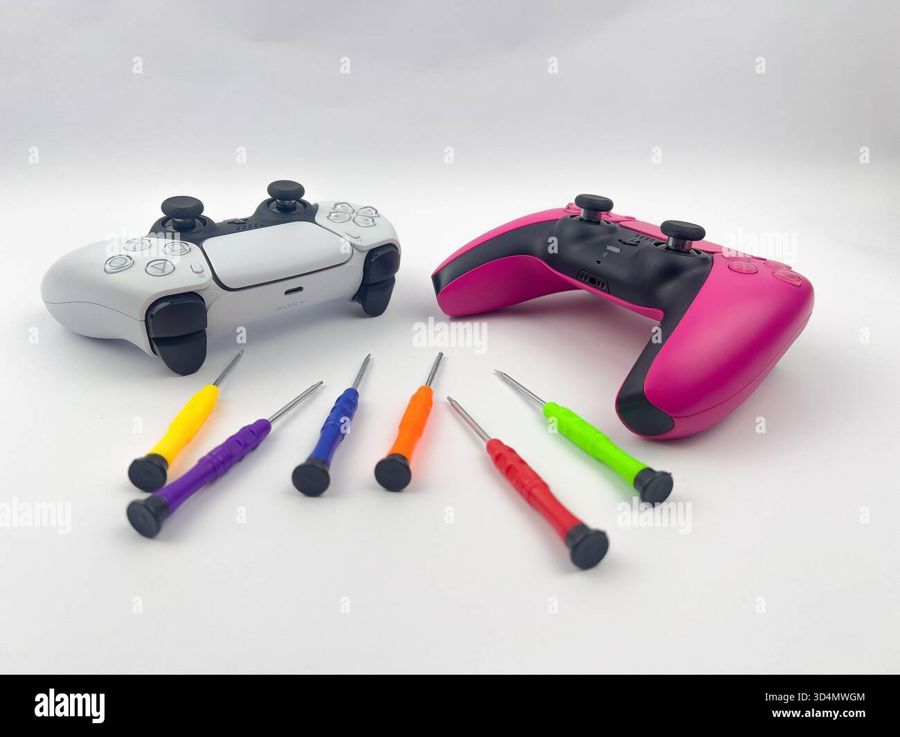 Two PlayStation 5 (PS5) DualSense controllers and a set of six colorful ...