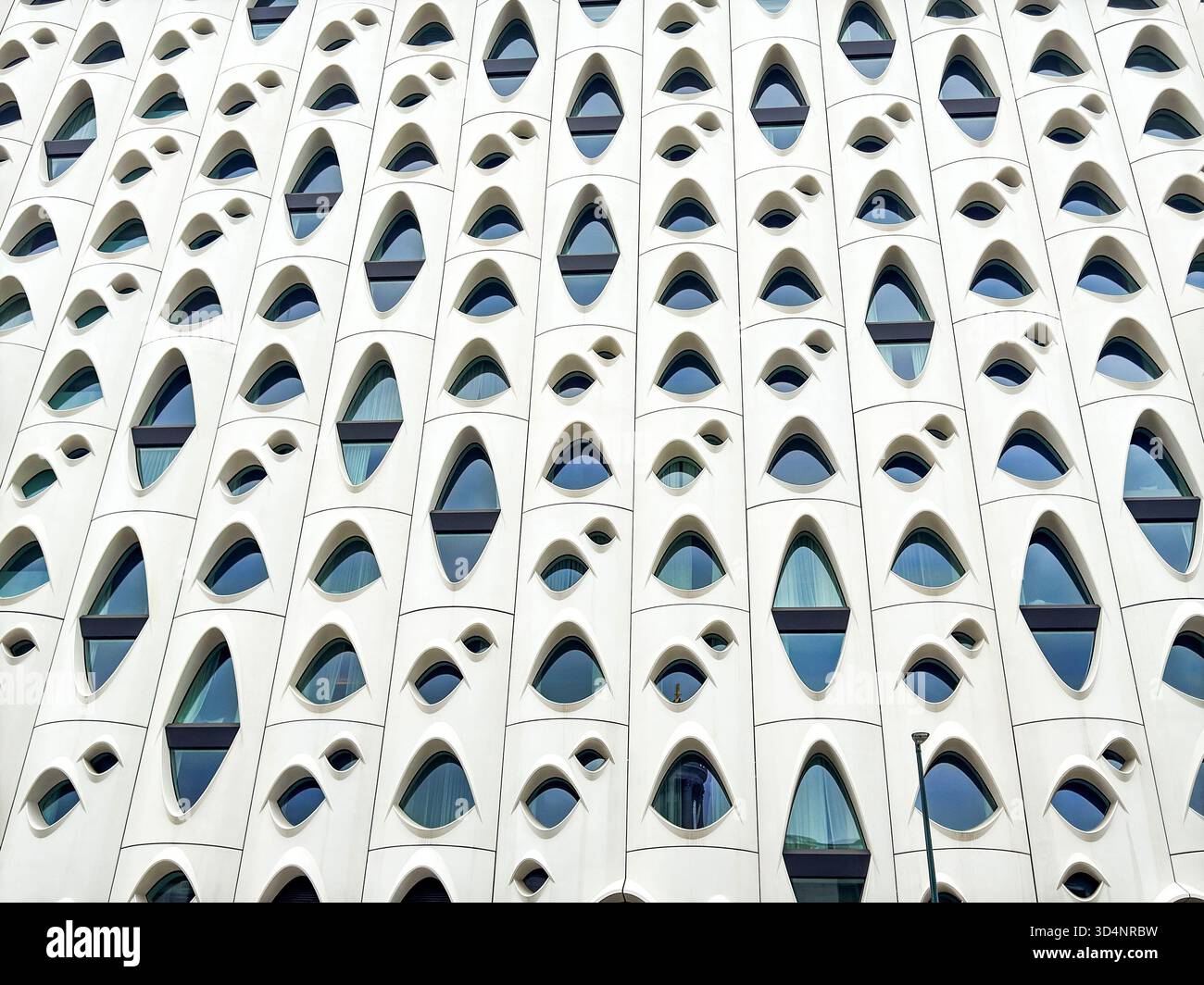 Denver, Colorado, USA - 2 June 2025: Close up of the exterior of the Populus Hotel in downtown Denver. The design has been compared to that of a chees - Smartphone Captured Stock Image