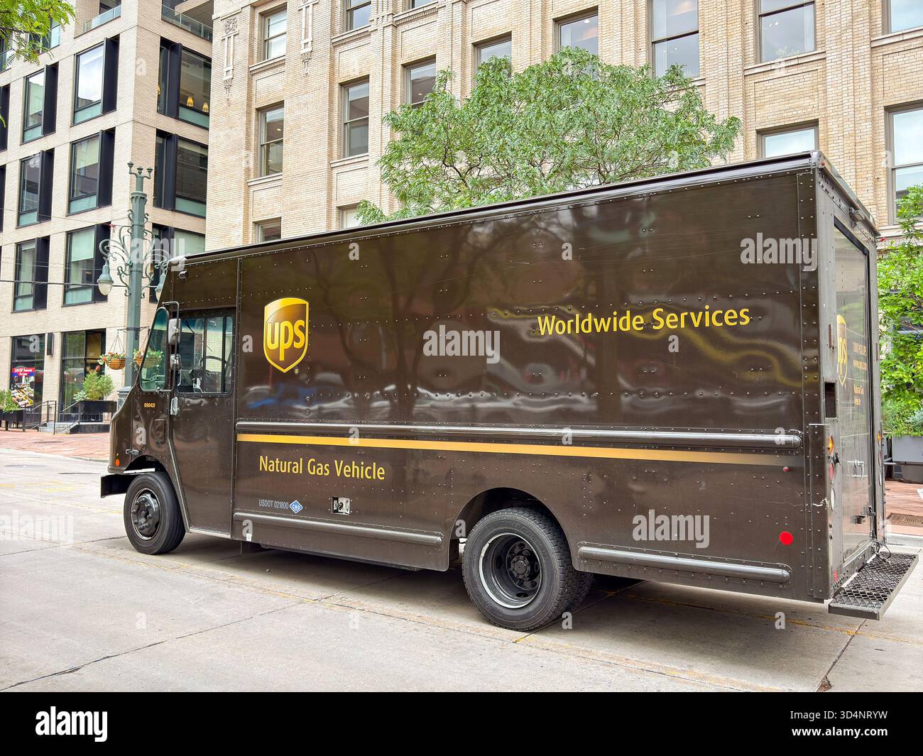 Denver, Colorado, USA - 2 June 2025: Delivery van used by the United Parcel Service UPS parked on a street in downtown Denver. The zero emissions vehi - Smartphone Captured Stock Image