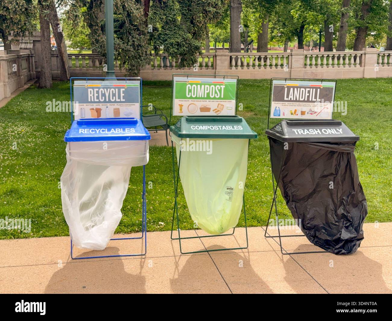 Denver, Colorado, USA - 2 June 2025: Trash bins for recycling, compost and landfill rubbist in a park in downtown Denver - Smartphone Captured Stock Image