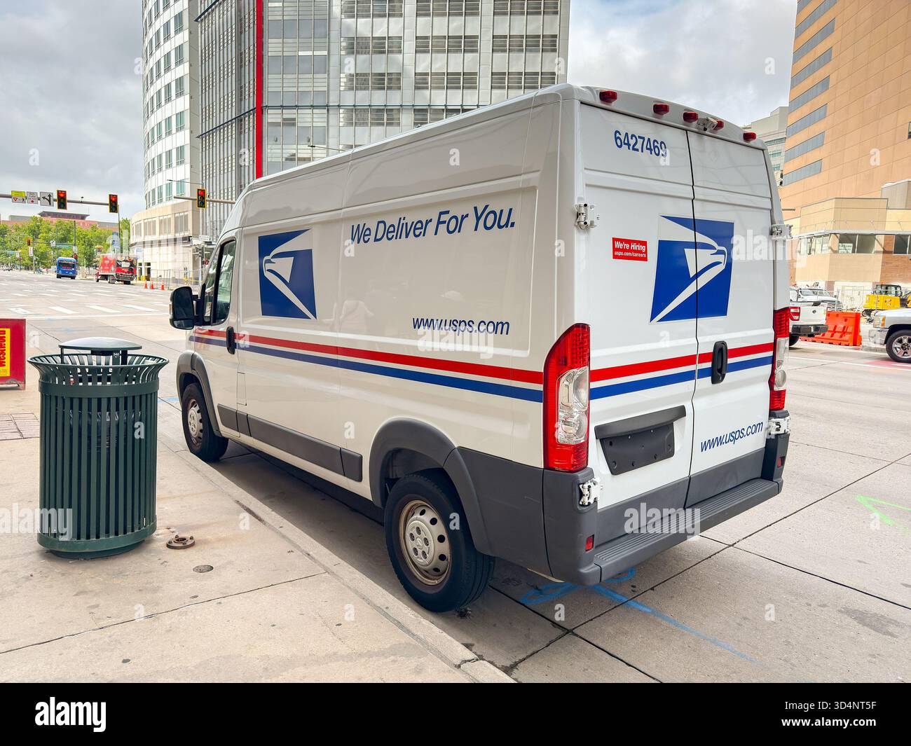 Denver, Colorado, USA - 2 June 2025: Mail delivery van used by the United States Postal Service parked on a street in downtown Denver. - Smartphone Captured Stock Image