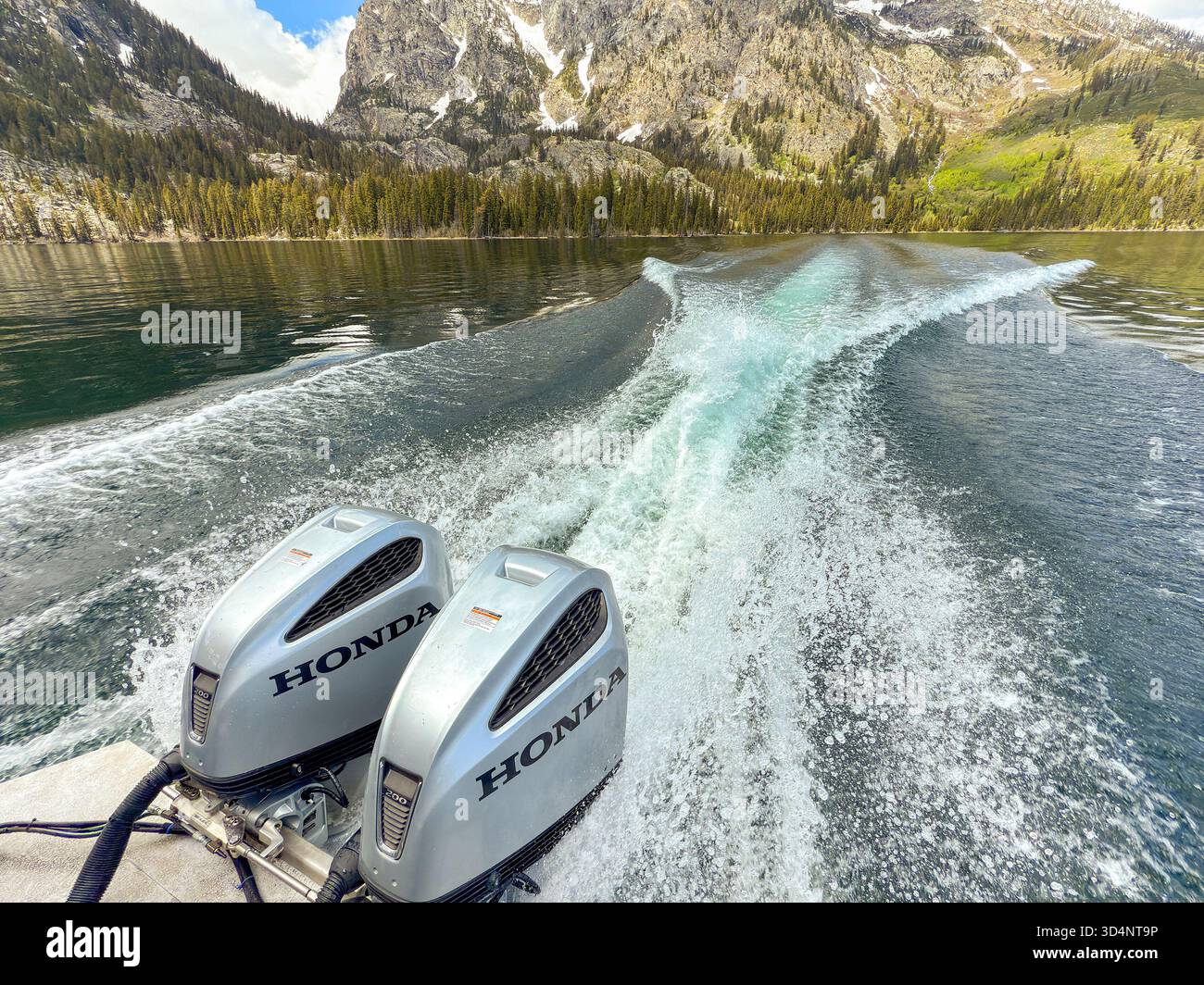 Jackson, Wyoming, USA - 28 May 2025: Wake from a fast boat powered by Honda electric outboard motor engines on Sally Lake in the Grand Teton National - Smartphone Captured Stock Image