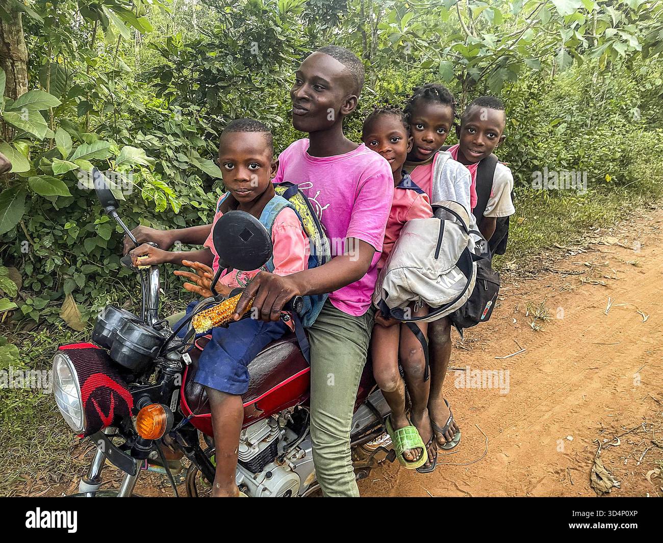 Children taken to school on a motorcycle in Allada, Benin. Children ...