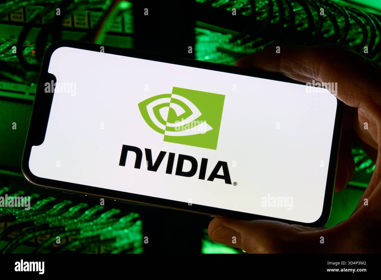 NVIDIA Logo on Smartphone with Server Hardware Background Stock Photo