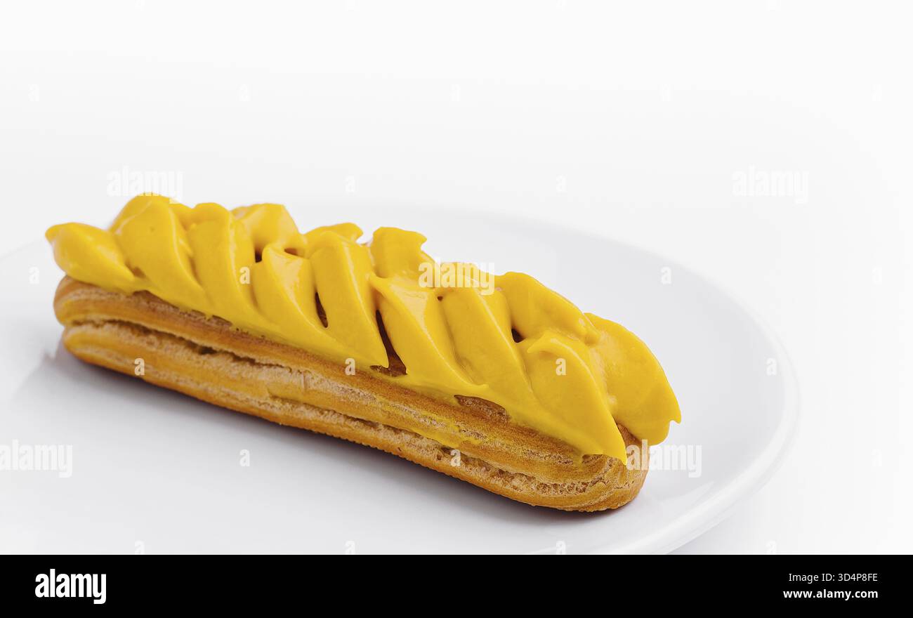 Food, Eclair with Mango Cream on White Plate Stock Photo