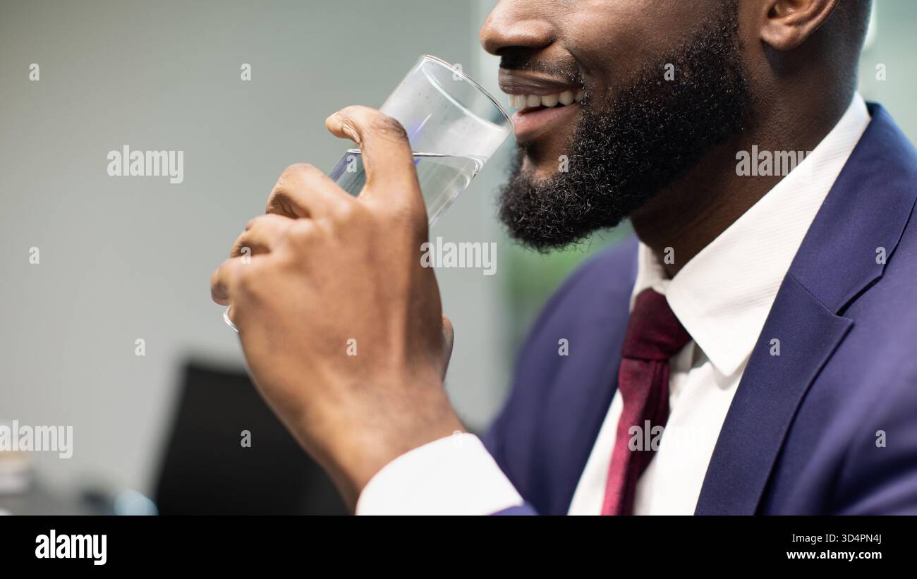 Unrecognizable black businessman drinking water, copy space Stock Photo