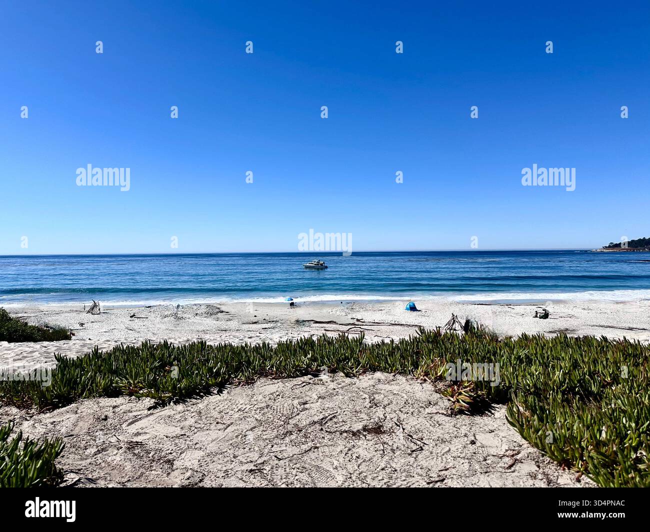 Boat offshore with waves and sandy beach, Monterey Bay California - Smartphone Captured Stock Image